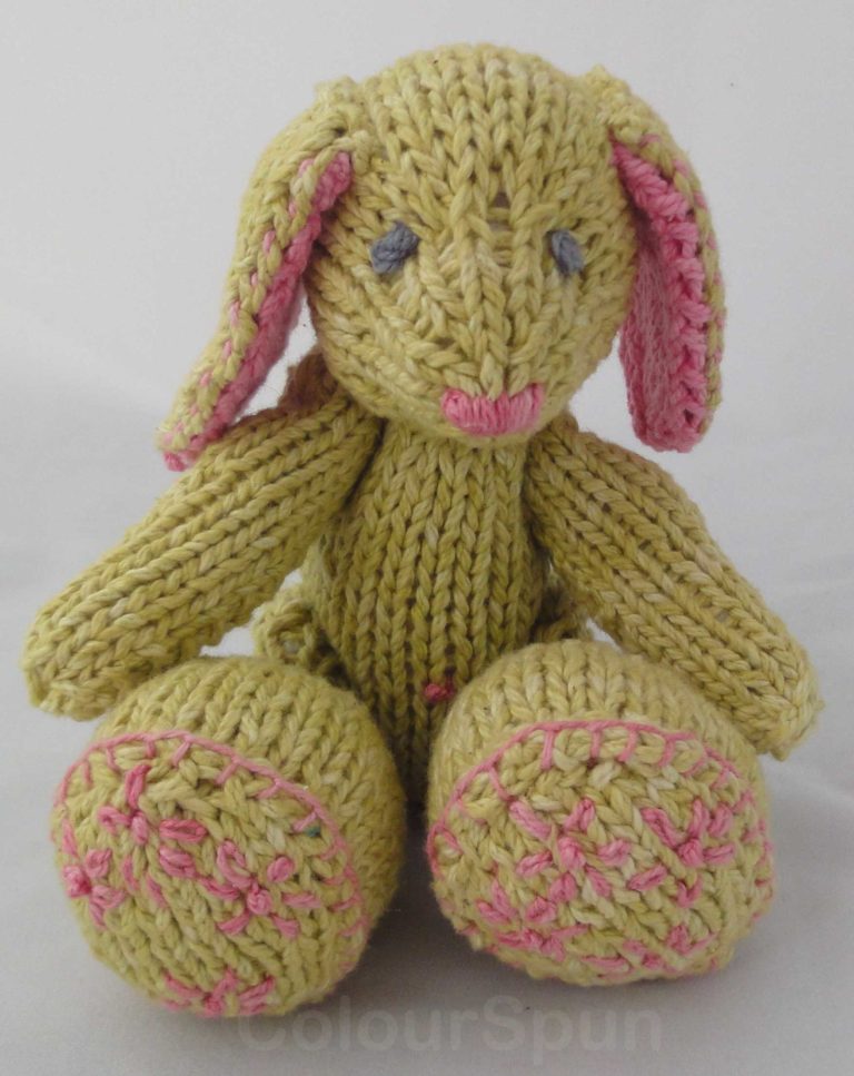 A soft green knit bunny with jointed arms and legs
