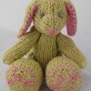 A soft green knit bunny with jointed arms and legs