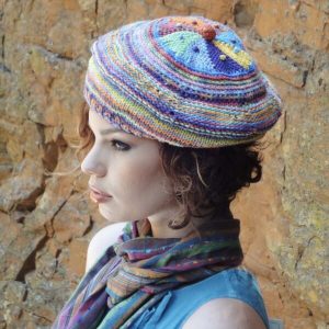 A ColourSpun Pure Cotton beret. worked from the centre of the crown out in wedges and circular stripes.. it is knit but has the option of adding crochet for extra texture