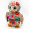 Aloysius the African Flower Owlet - Colorful crocheted owl made from hexagon and pentagon flower motifs, with black button eyes, orange beak, and textured brown wings.