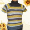 Crocheted Sunflower Road Tee on a mannequin over a black polo neck, with a square neckline and stripes of mustard yellow, charcoal grey and light grey, against a cream background with sunflowers.