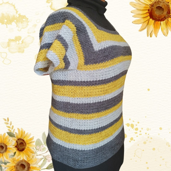 Side view of the Sunflower Road Tee on a mannequin, showing the short sleeve and the stripes of mustard yellow, charcoal grey and light grey, with sunflowers in the background.