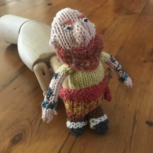 Dada the Pirate Finger Puppet on a wooden hand.
