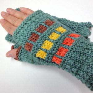 Green fingerless Mittens with with brown, yellow and orange block pattern worn on a hand