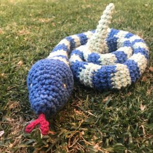 Ssslither the Snake - a crochet toy snake curled up - front view