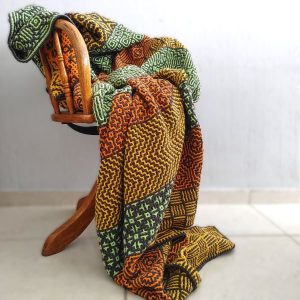 Wacky Weave Ndebele Blanket draped over a wooden chair.