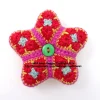 Handmade crocheted star decorations with buttons, colourful yarn craft by Heidi Bears Designs. Little Star Red