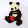 Sitting crochet panda bear holding a red and green crocheted apple, handmade amigurumi toy crafted with soft yarn and button eyes by Heidi Bears Designs.