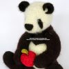 Close up of crochet panda bear holding a red and green crocheted apple, handmade amigurumi toy crafted with soft yarn and button eyes by Heidi Bears Designs.
