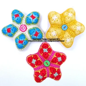 Handmade crocheted star decorations with buttons, colourful yarn craft by Heidi Bears Designs.