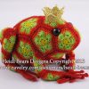 Crocheted frog prince toy made with red and green African flower motifs, featuring a golden crown and black button eyes; handcrafted using hexagons and pentagons pattern by Heidi Bears Designs.