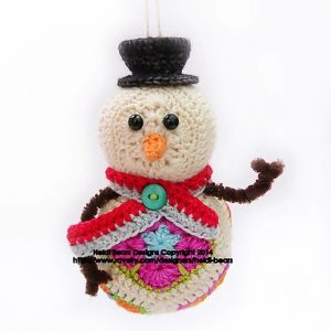 Twig the Snowman soft toy made from colourful African flower motifs, featuring a cream head with black button eyes, crochet carrot nose, and red scarf; handmade using vibrant hexagons and pentagons —pattern by Heidi Bears Designs.