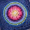 Owlie 2.0 crochet kit Multicoloured crocheted mandala square with textured concentric rounds framed in dark blue