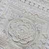Close up of the centre medallion of Mixology Edition 6 by Hooked on Sunshine, worked in cream Cotton Scintilla DK, showing layered petal texture surrounded by lace and bobble stitch borders in a square layout