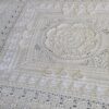 Close up of the centre medallion of Mixology Edition 6 by Hooked on Sunshine, worked in cream Cotton Scintilla DK, showing layered petal texture surrounded by lace and bobble stitch borders in a square layout