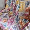 The Namaqua Blanket draped over a pale armchair indoors